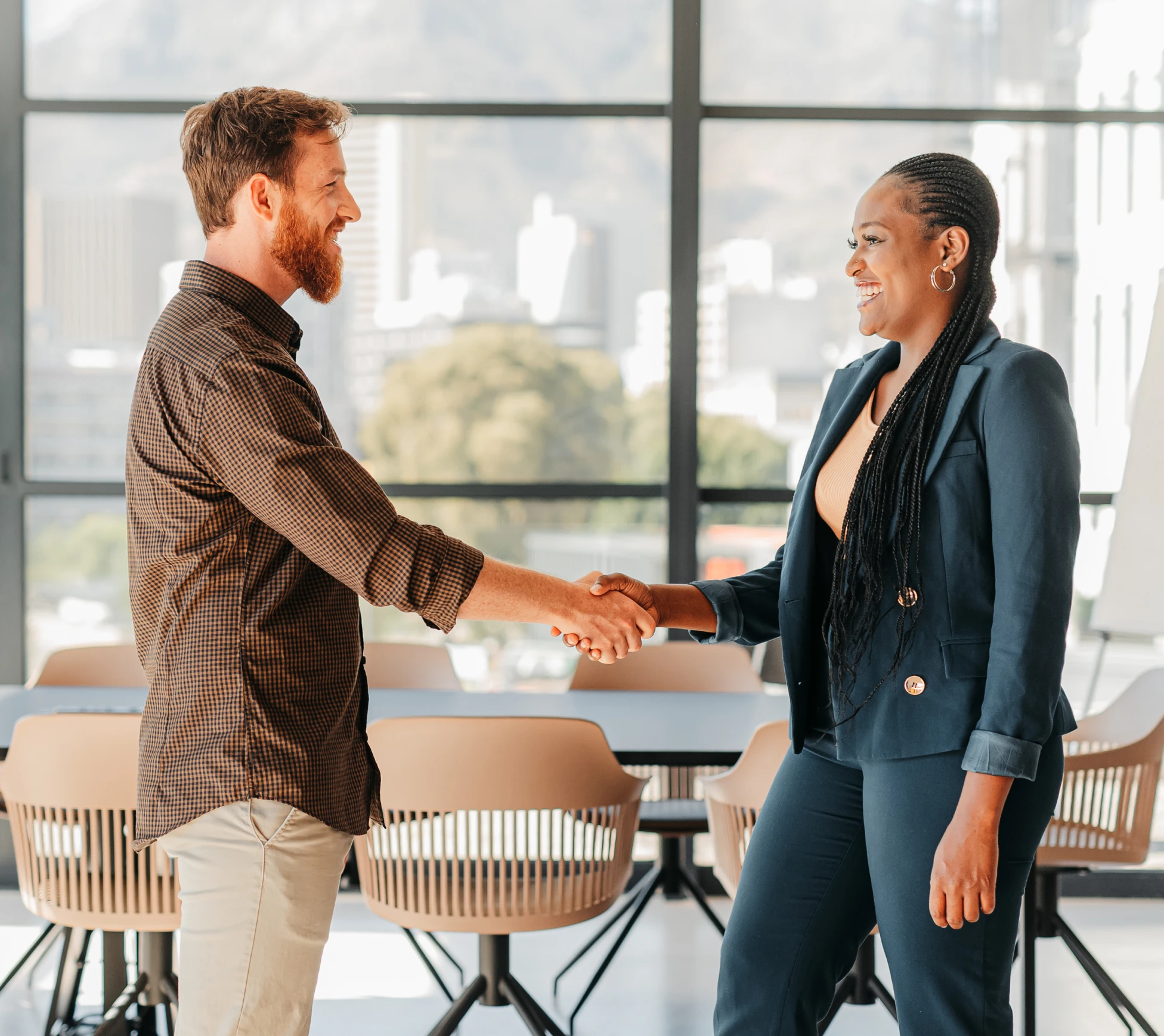 Business meeting handshake in modern office